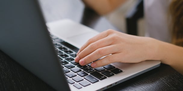 Woman typing on a laptop